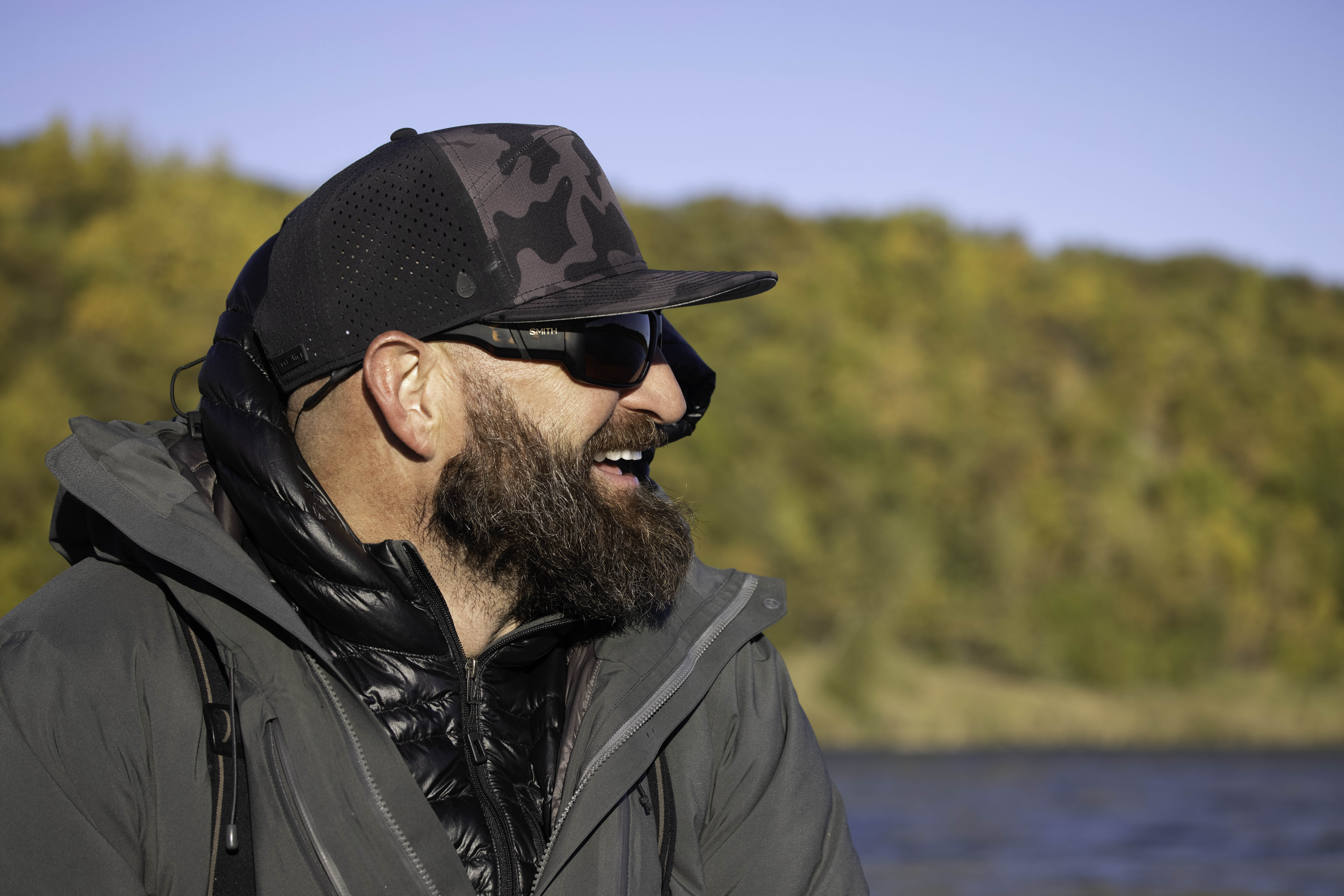A man laughing on the water — completely present, not looking at a phone